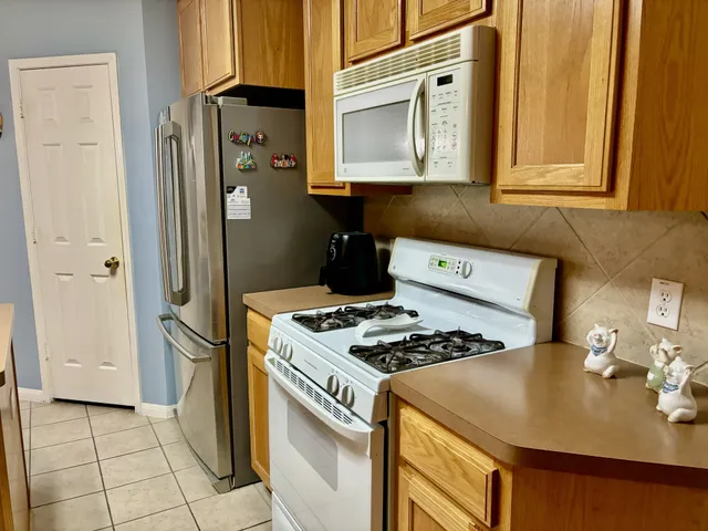 a kitchen with a table chairs and wooden floor
