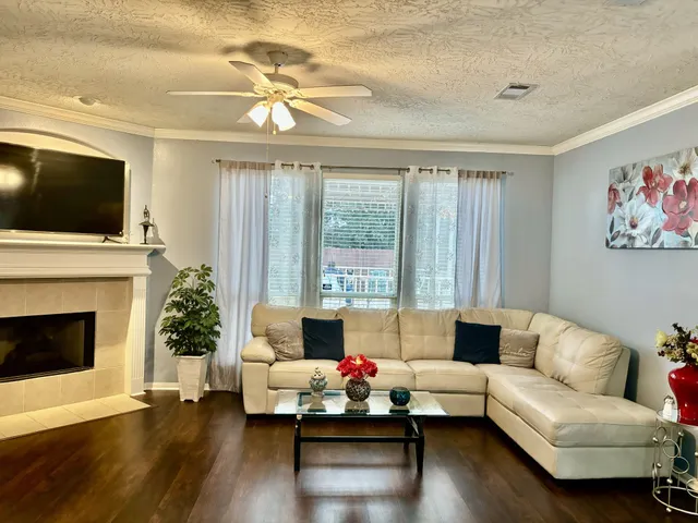 a bed sitting in a bedroom next to a window and a chandelier