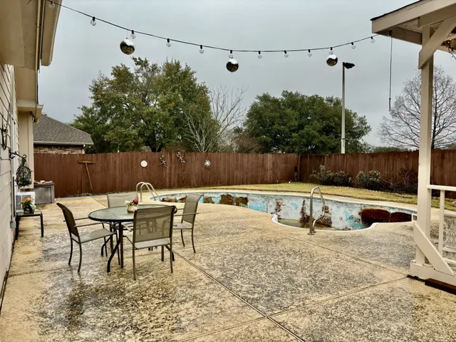 a view of a swimming pool with a yard