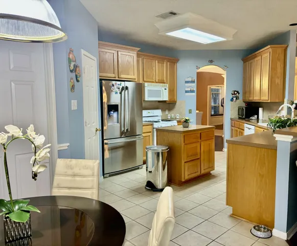 a kitchen with stainless steel appliances a sink a stove and a counter space