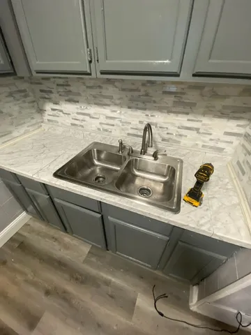 a kitchen sink with granite countertop