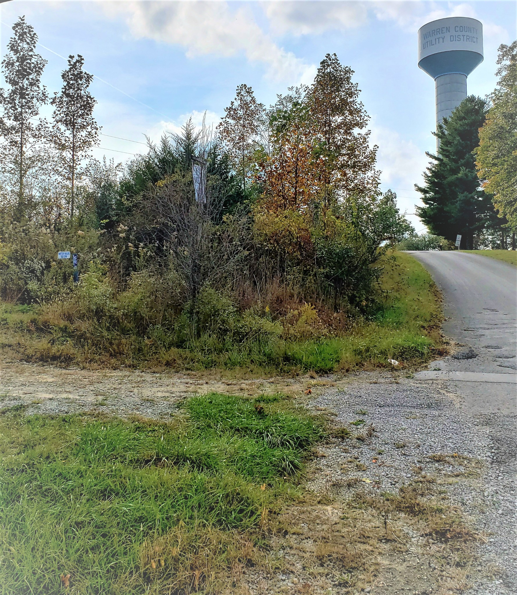 a view of a dirt road and a building