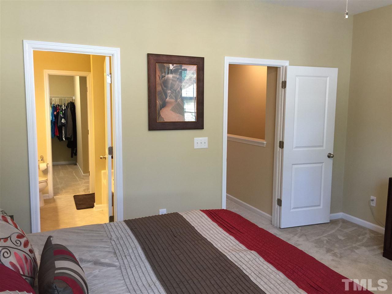 721 Wickham Ridge Road Apex, NC 27539 - Photo 12 of 25 a bedroom with a bed and wooden floor
