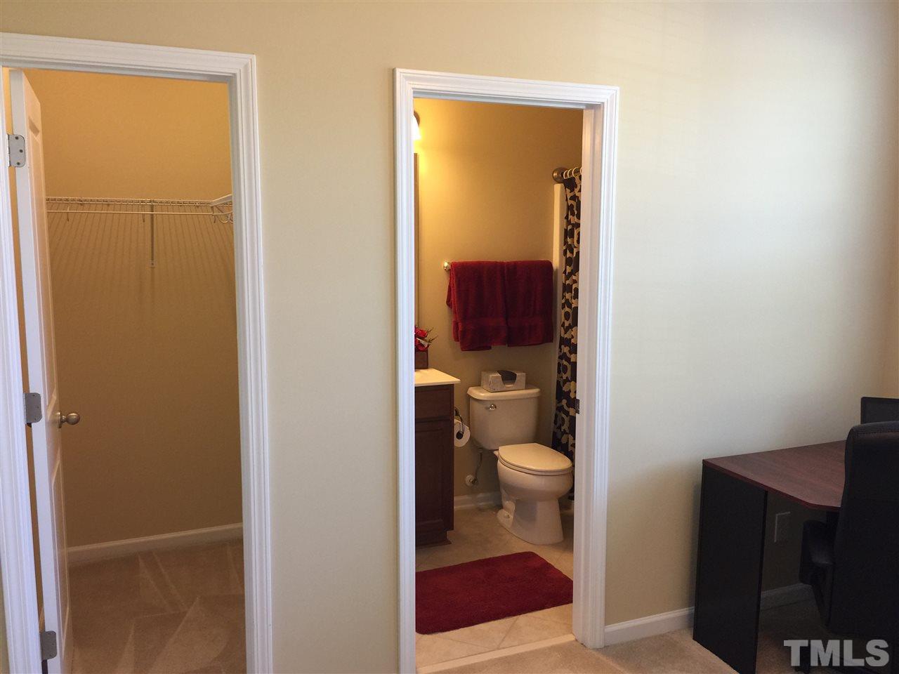 721 Wickham Ridge Road Apex, NC 27539 - Photo 16 of 25 a bathroom with a toilet and a sink