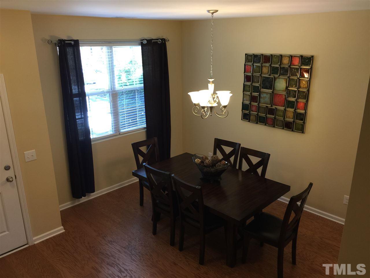 721 Wickham Ridge Road Apex, NC 27539 - Photo 3 of 25 a view of a dining room with furniture and window