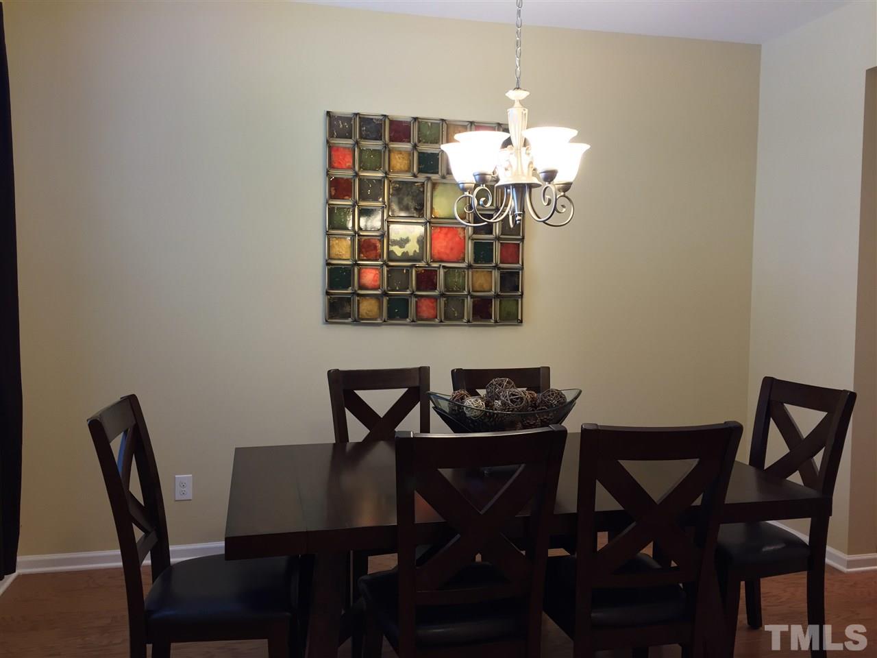 721 Wickham Ridge Road Apex, NC 27539 - Photo 4 of 25 a view of a dining room with furniture and wooden floor