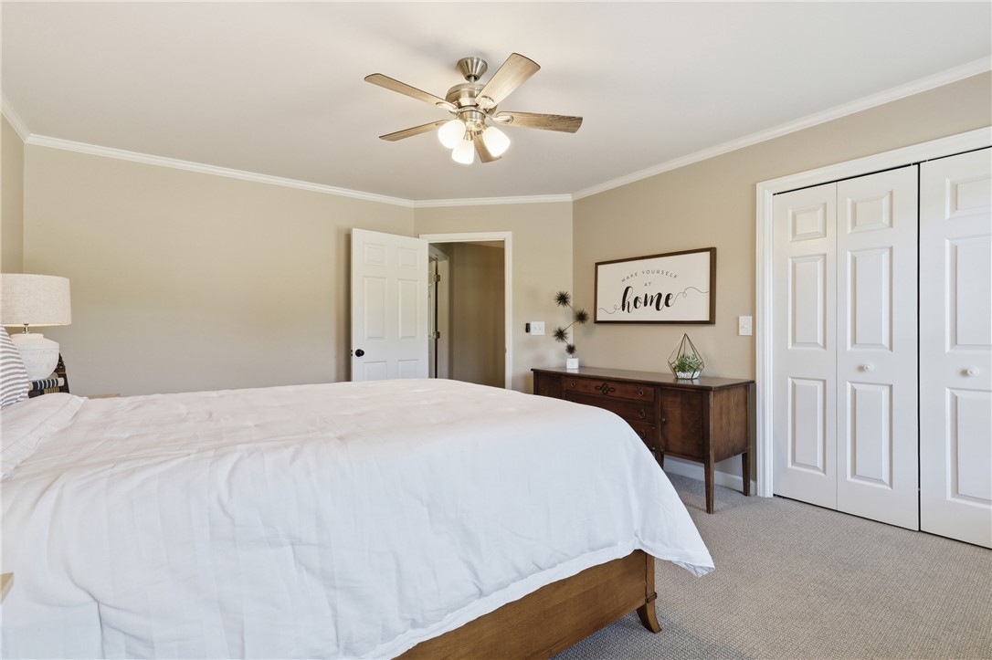 103 5 Knoll Court Anderson, SC 29621 - Photo 22 of 33 A comforting bedroom space featuring a ceiling fan, closet, and a plush carpeted floor.