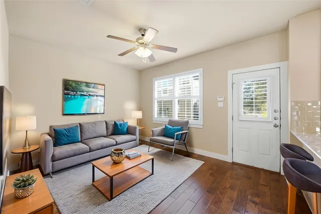 a view of a livingroom with a ceiling fan and window