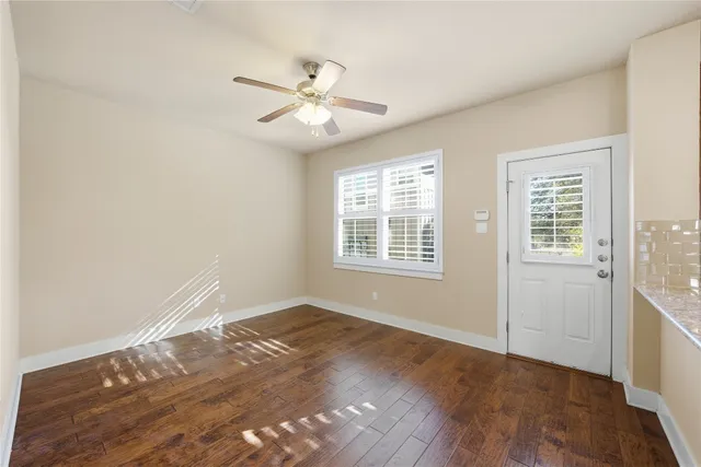 a bathroom with a granite countertop sink and a large mirror
