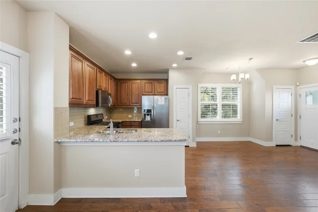 a bathroom with a granite countertop sink a toilet and shower