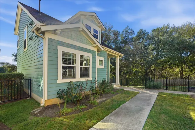 a kitchen with stainless steel appliances granite countertop a stove a refrigerator and a granite counter tops with wooden floors