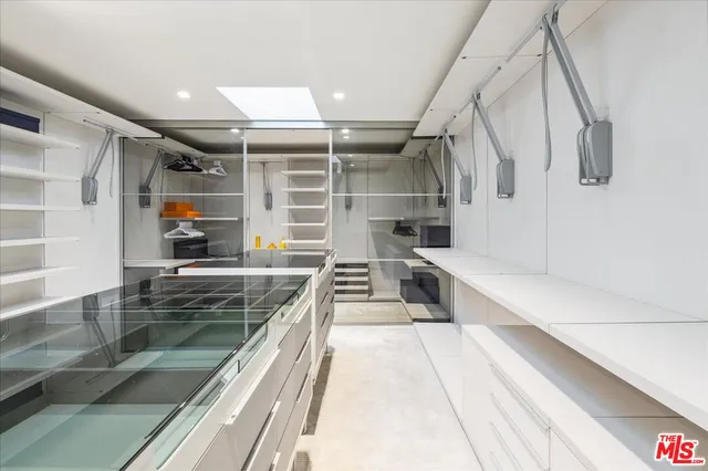 a bedroom with a balcony a large bed and a potted plant