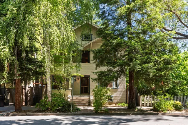 a front view of a house with trees
