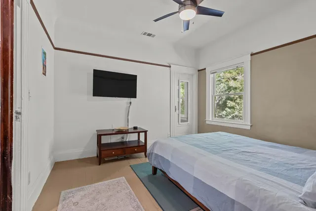 a bedroom with a bed and a flat screen tv