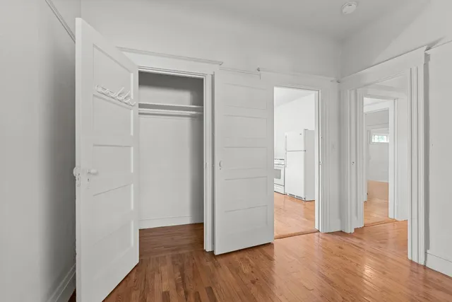 a view of a hallway with wooden floor