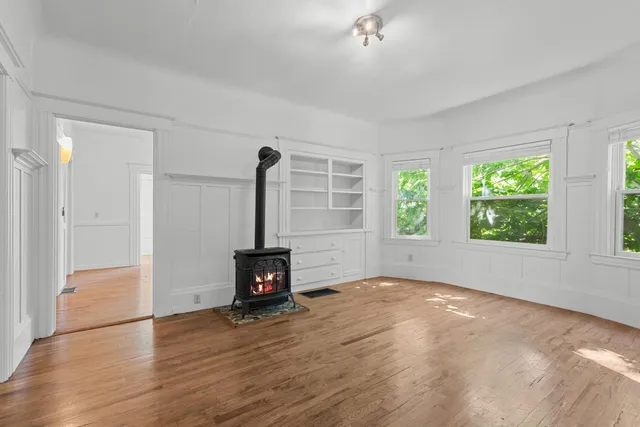 wooden floor in an empty room with a window