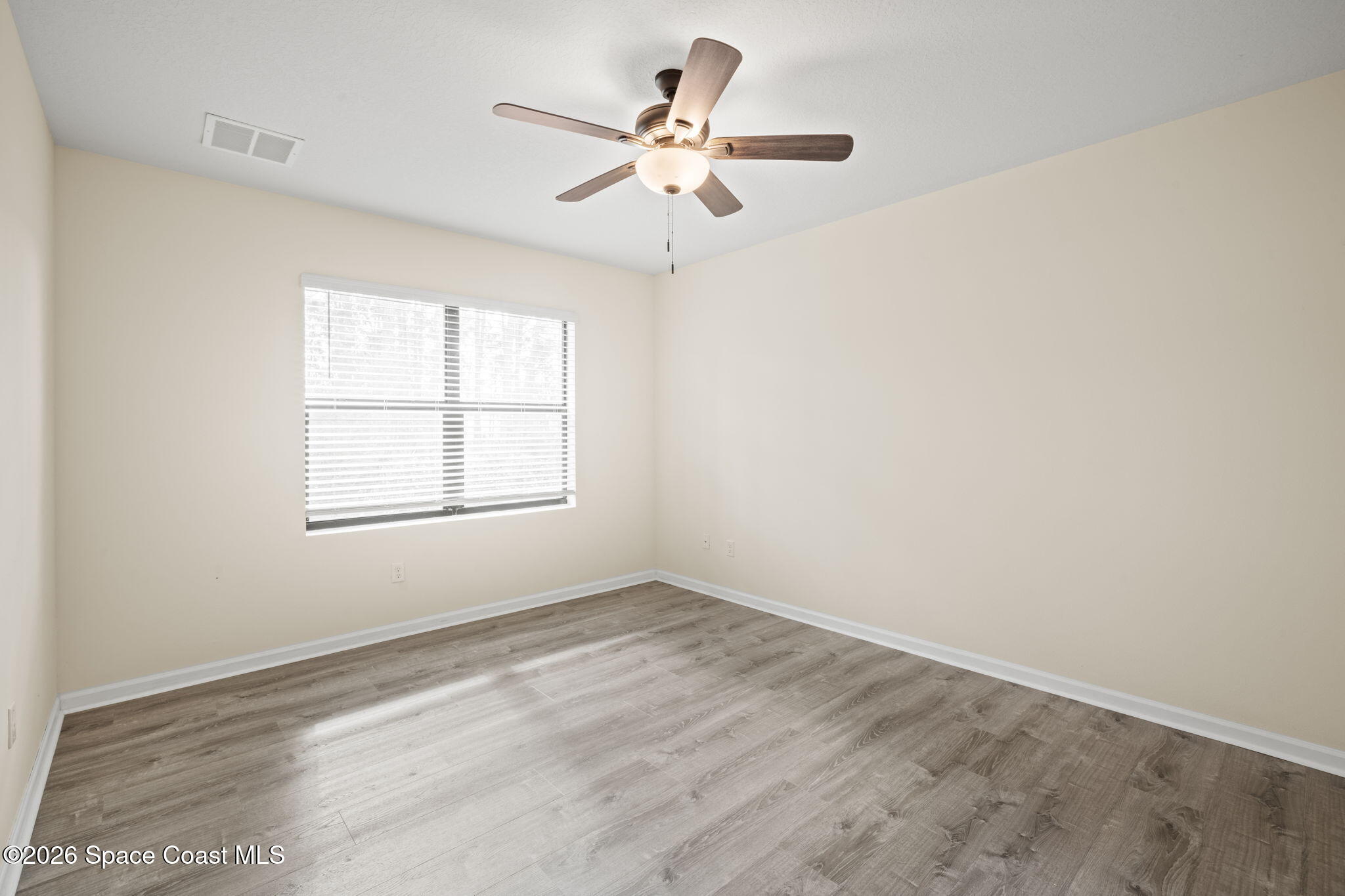 4412 Talbot Boulevard Cocoa, FL 32926 - Photo 15 of 32 an empty room with a window and a fan