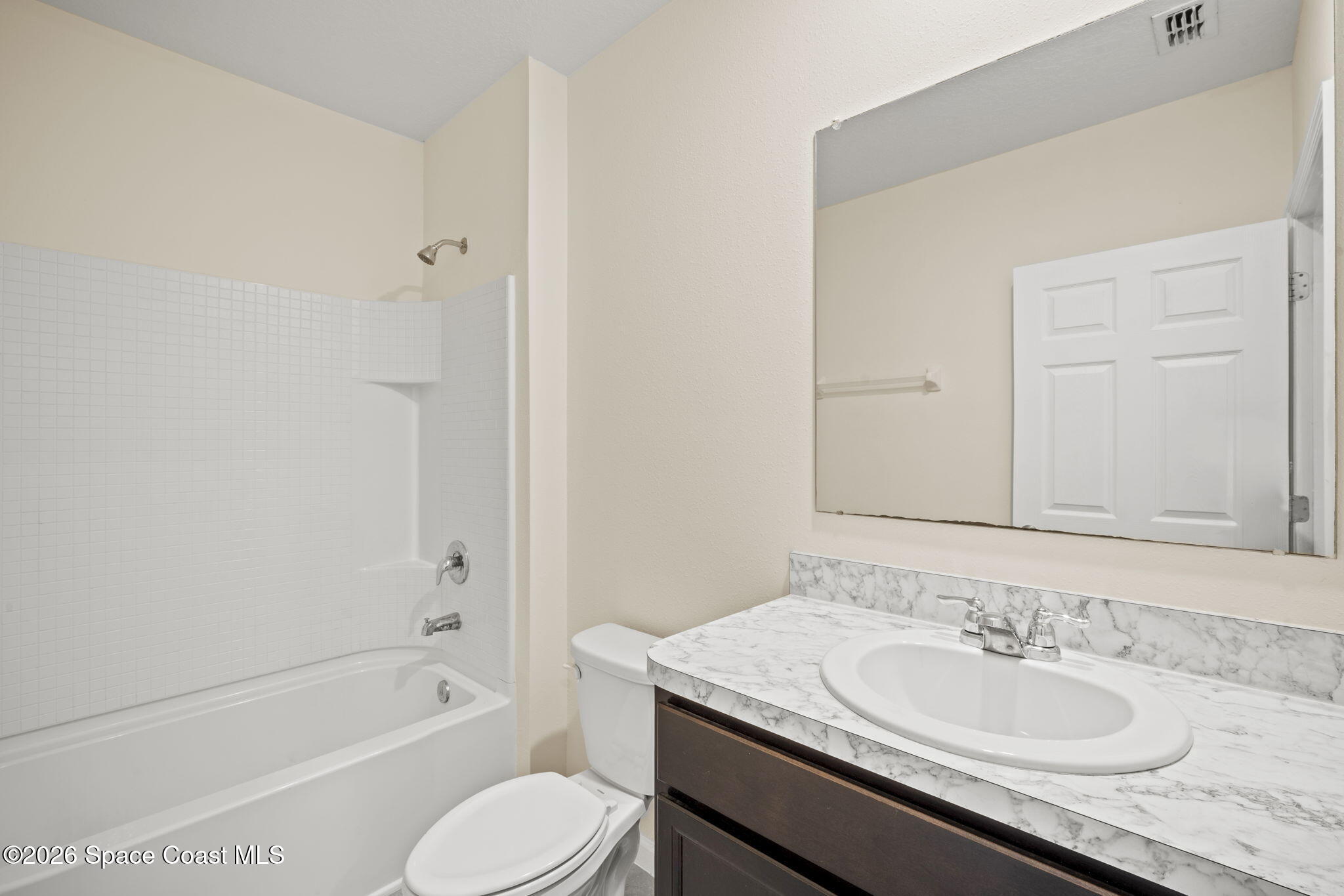 4412 Talbot Boulevard Cocoa, FL 32926 - Photo 25 of 32 a bathroom with a granite countertop sink toilet and shower