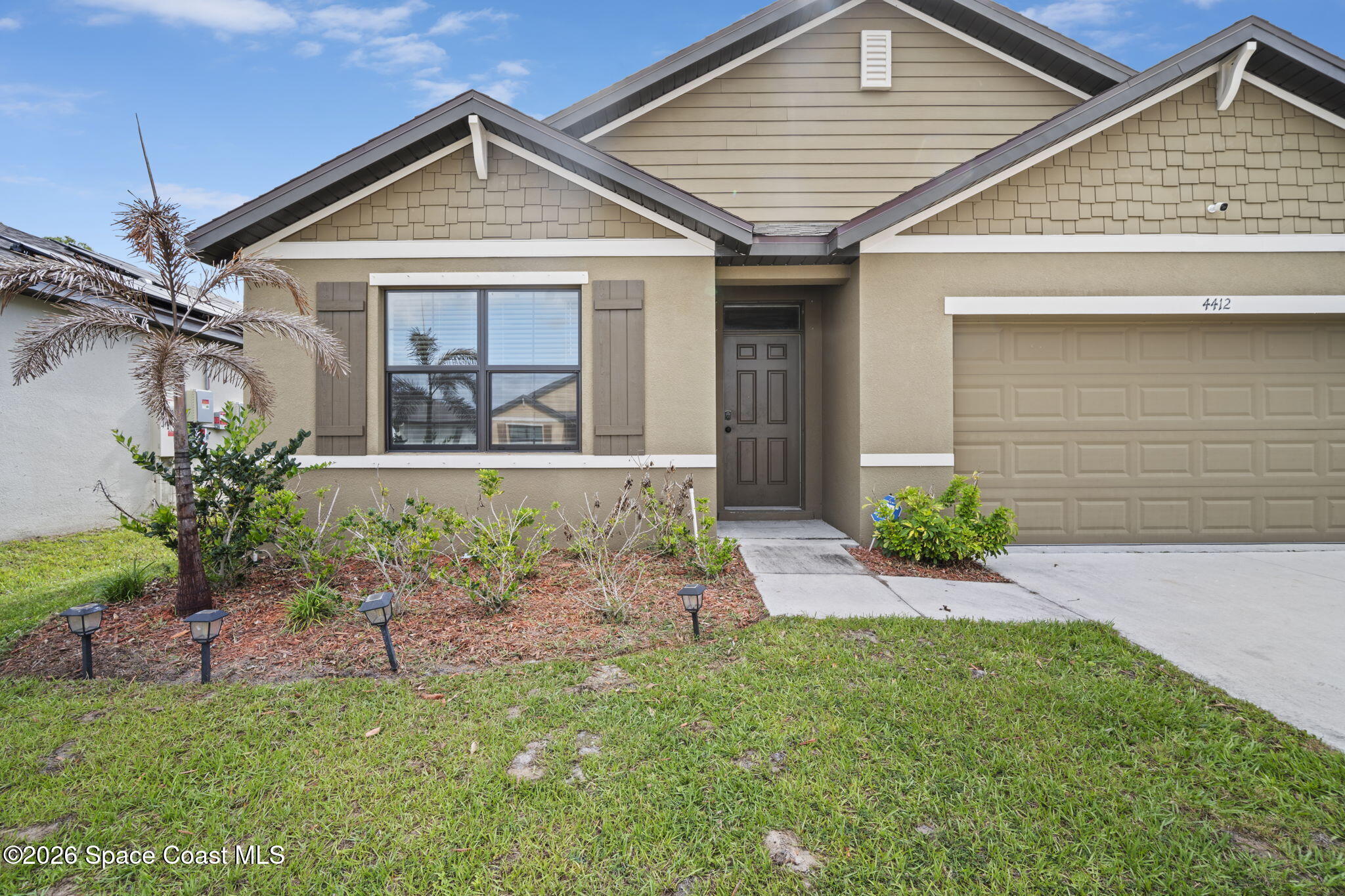 4412 Talbot Boulevard Cocoa, FL 32926 - Photo 3 of 32 a front view of a house with a garden and plants