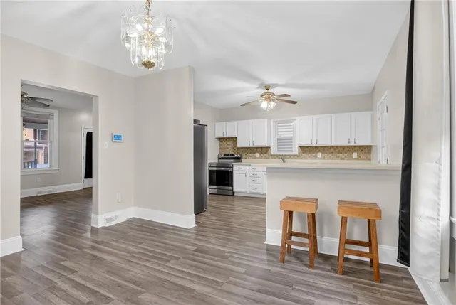 a view of kitchen with cabinets and wooden floor