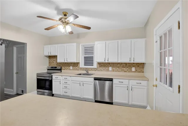 a kitchen with a sink stove and cabinets
