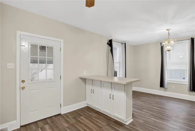an view of a kitchen with wooden floor and a sink