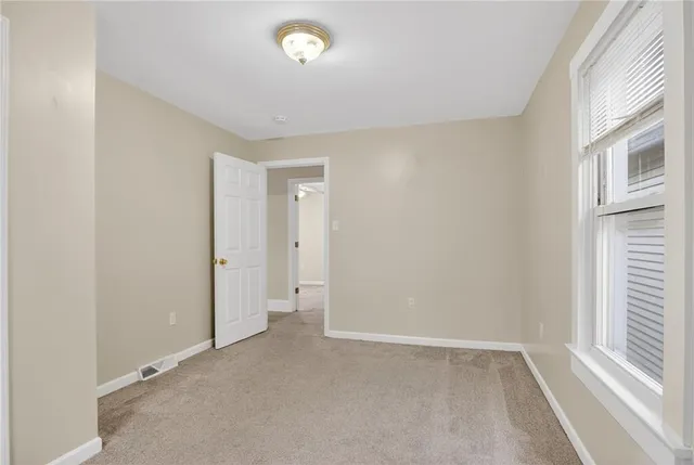 an empty room with a empty space and a window