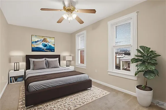 a bedroom with a large bed and a chandelier