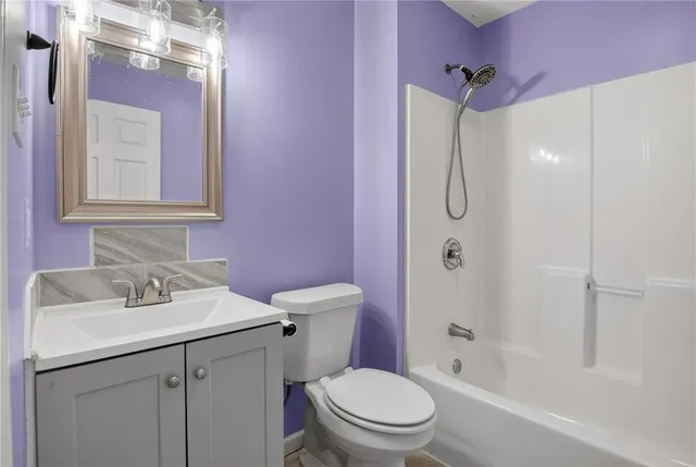 a bathroom with a sink toilet vanity and shower