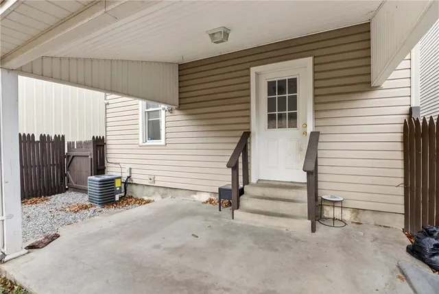 a view of a patio with a table and chairs and a barbeque