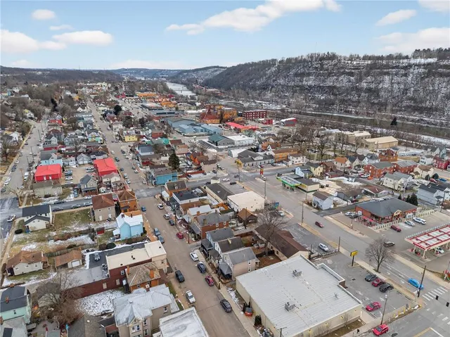 an aerial view of residential houses with city view