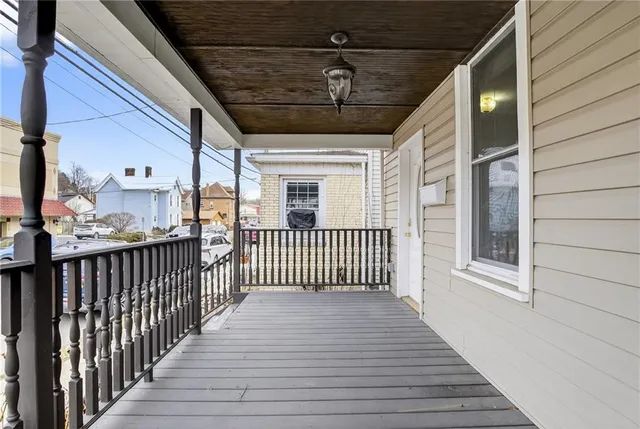 a view of a porch with wooden floor