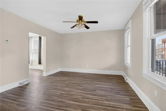 wooden floor in an empty room with a window