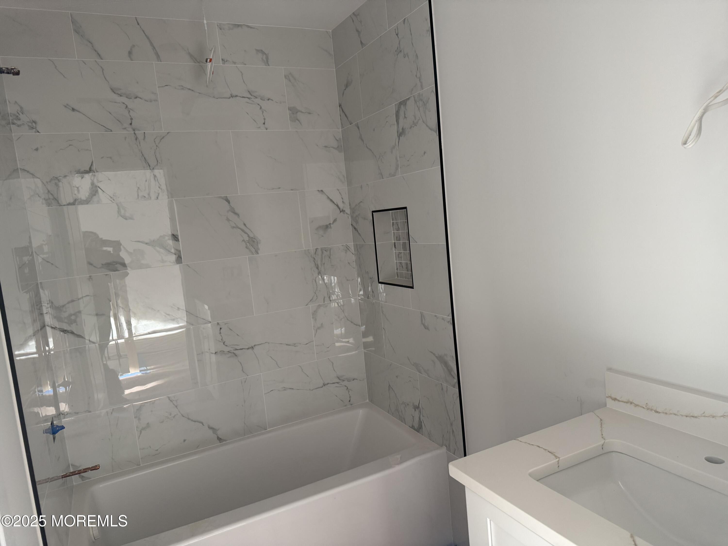 68 Main Street Manalapan, NJ 07726 - Photo 20 of 24 a bathroom with a sink and shower