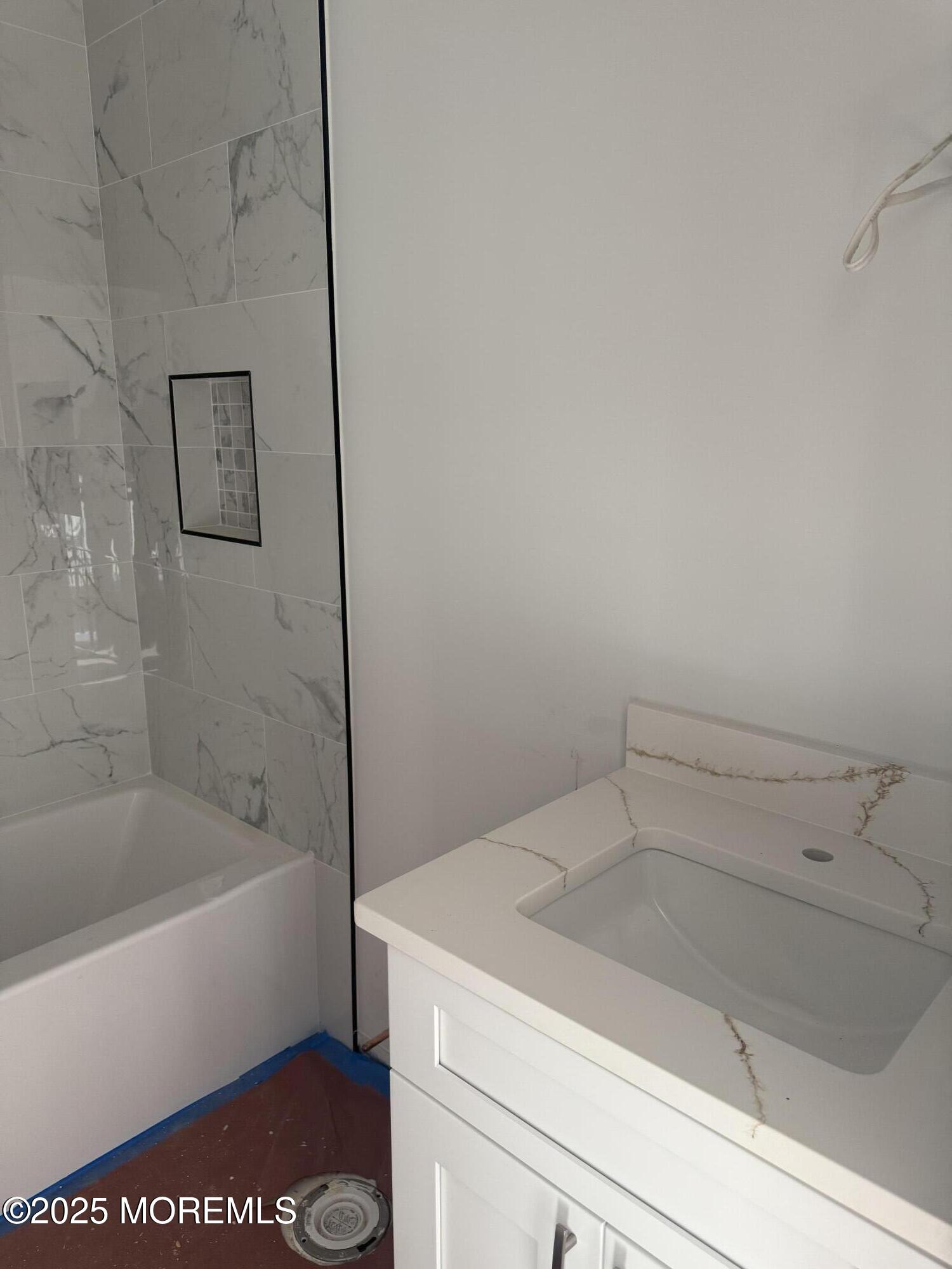 68 Main Street Manalapan, NJ 07726 - Photo 21 of 24 a bathroom with a bathtub and shower
