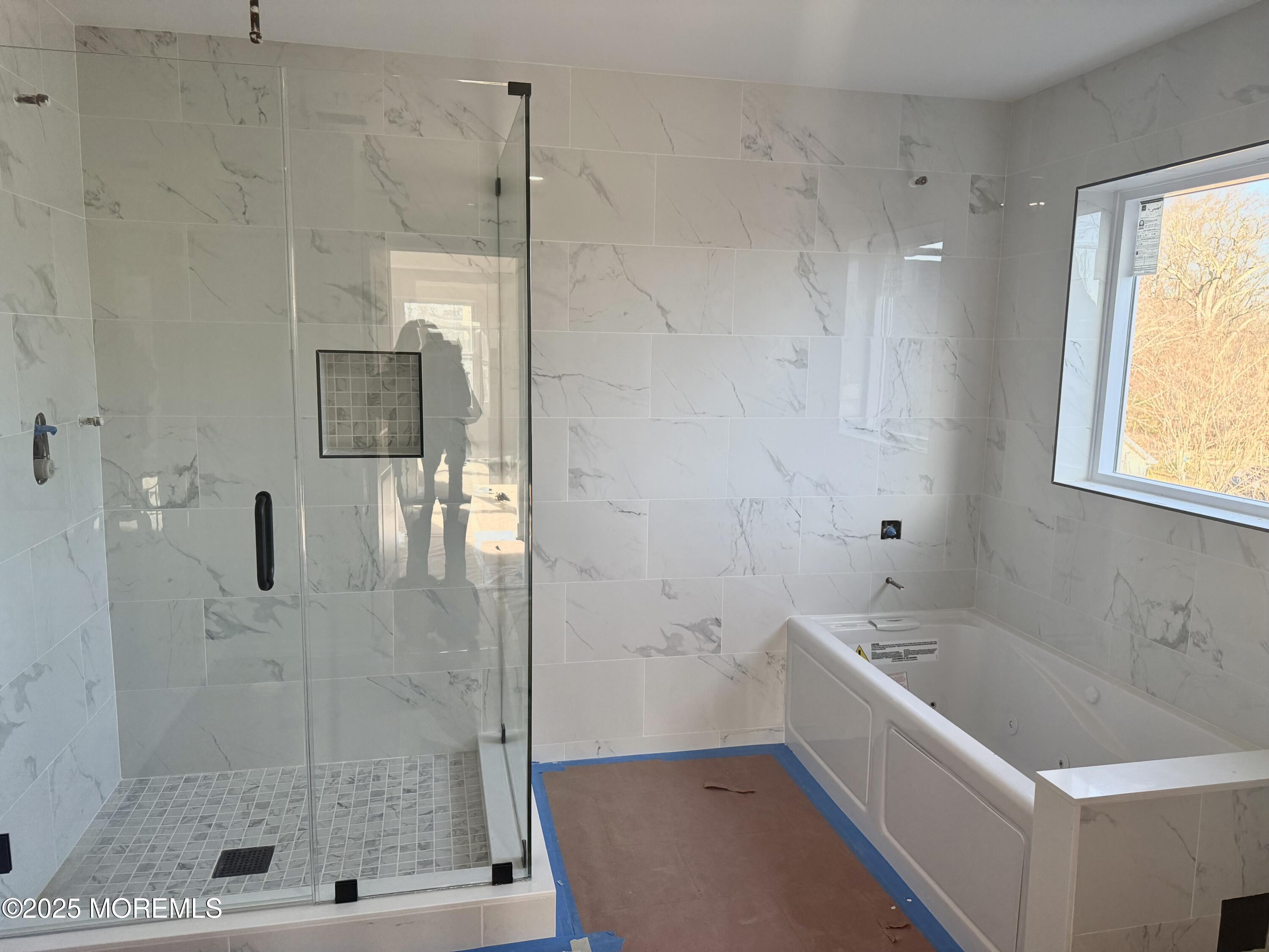 68 Main Street Manalapan, NJ 07726 - Photo 22 of 24 a bathroom with a bathtub and shower