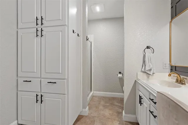 a bathroom with a sink vanity and a mirror