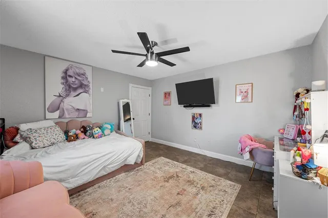 a bedroom with furniture and a flat screen tv