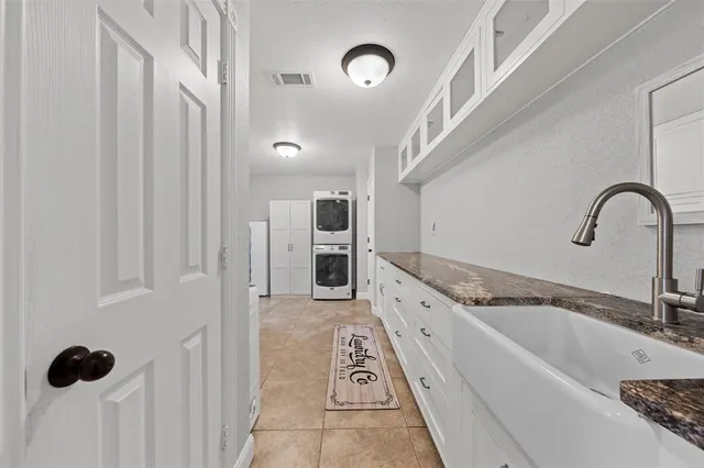 a kitchen with stainless steel appliances granite countertop a sink and a refrigerator