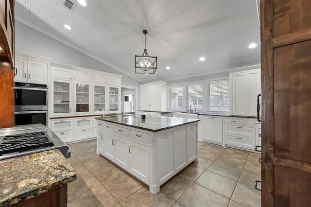 a kitchen with stainless steel appliances granite countertop a stove and a sink