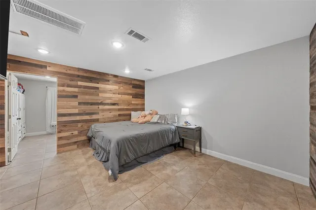 a spacious bedroom with a bed and a view of walk in closet