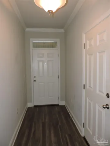 a view of a small space with wooden floor and a window