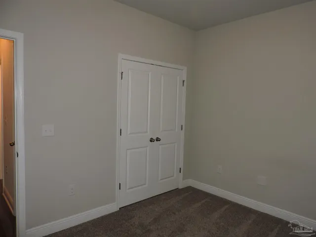 a bathroom with a granite countertop sink toilet a mirror and shower