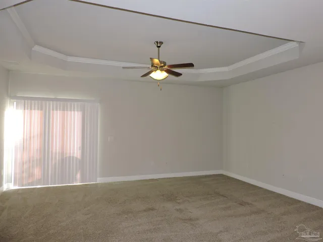 a very nice looking room with a ceiling fan and window