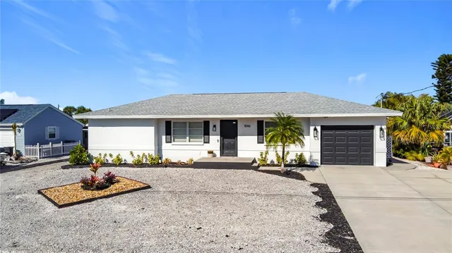 a front view of a house with a garden and patio