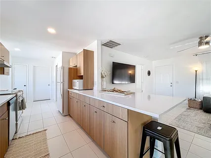 a kitchen with stainless steel appliances a sink and a refrigerator
