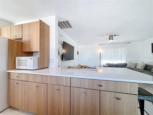 a kitchen with a sink cabinets and window