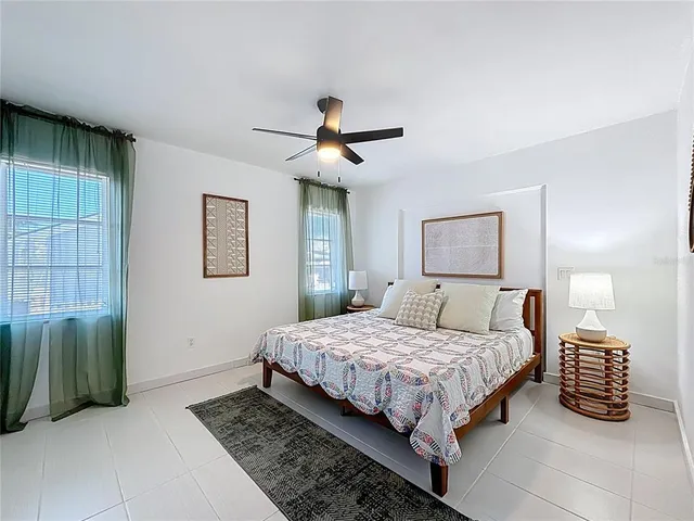 a bedroom with a bed tv and window