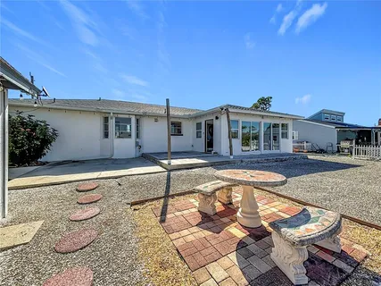a aerial view of a house with swimming pool and large trees