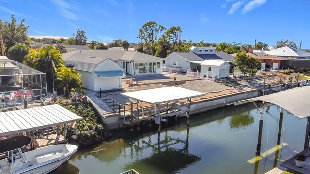 an aerial view of a house with swimming pool and patio